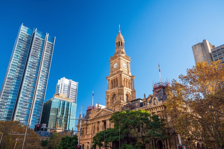 Sydney Town Hall under a clear blue sky.