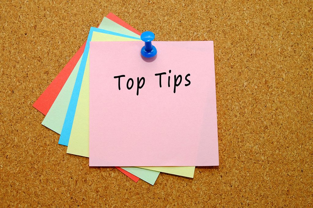 Five coloured sticky notes pinned to a corkboard and the top note reads 'Top tips'