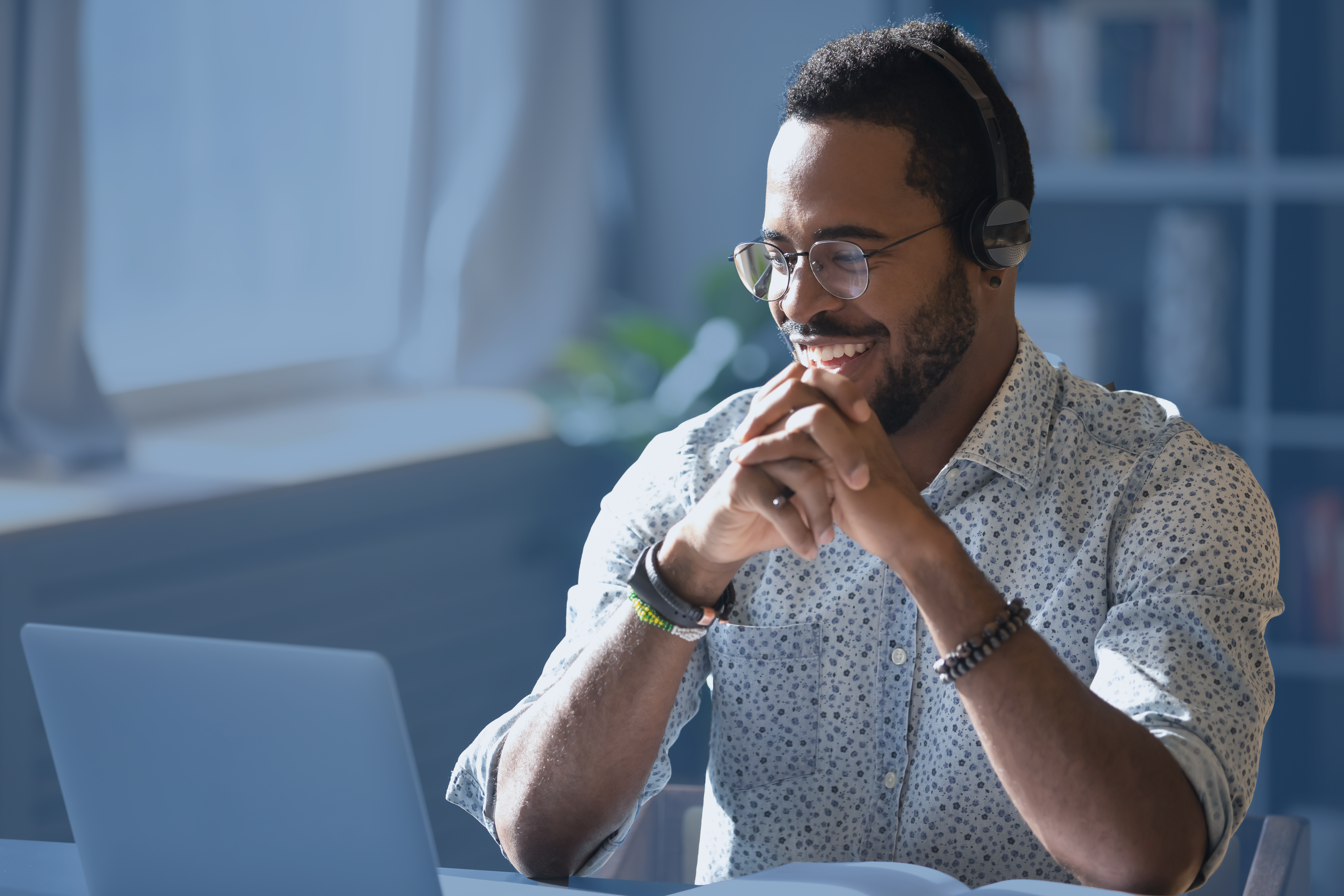 A smiling participant attends an online business writing course.