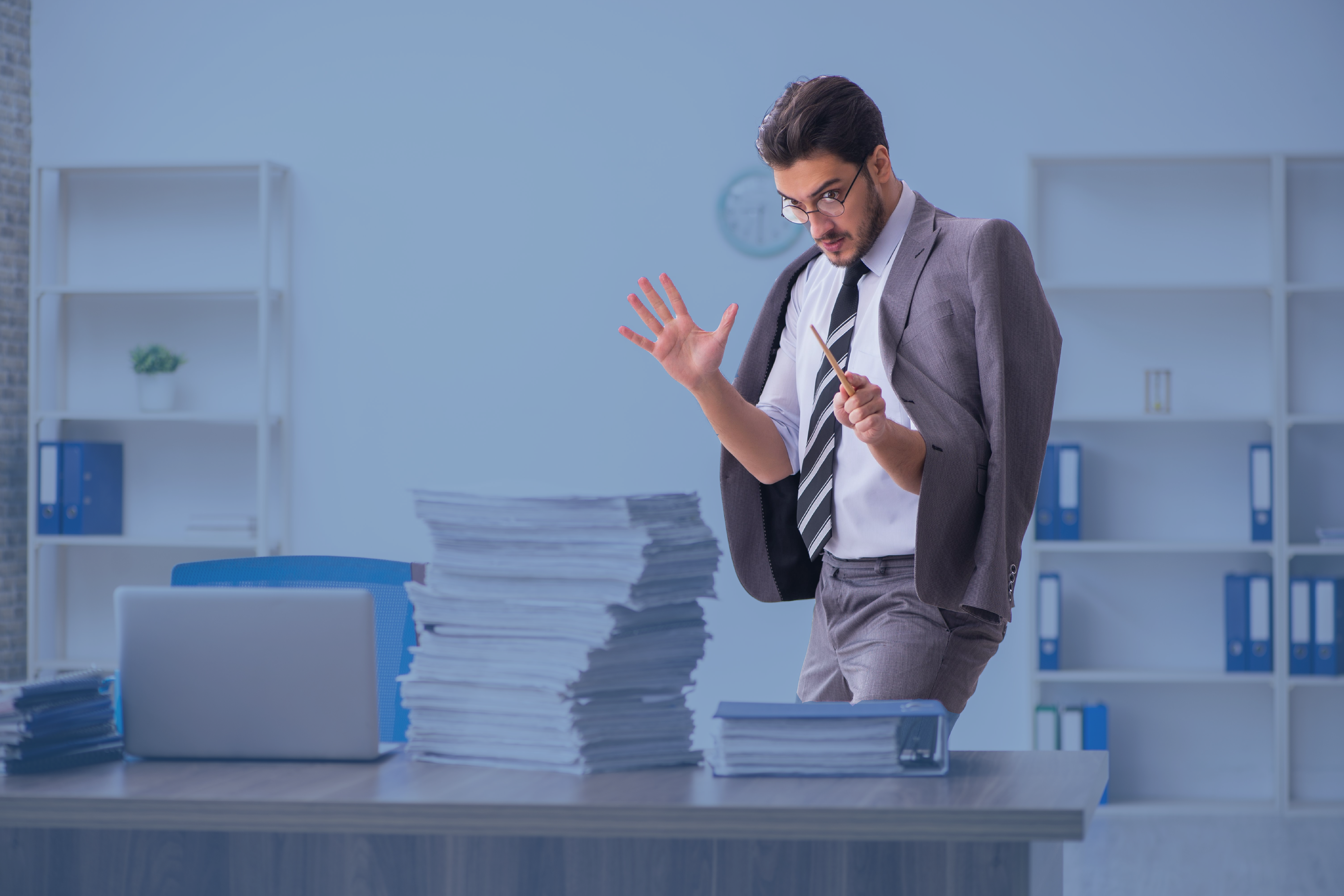 White-collar worker performs magic on a stack of templates.