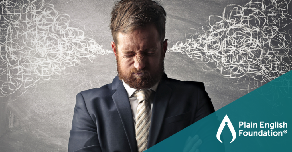 A frustrated corporate worker has steam coming out of his ears. The Plain English Foundation logo sits in the bottom right-hand corner.