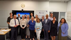Plain English Foundation and Blacktown City Council representatives stand in a group in front of a Plain English Foundation banner.